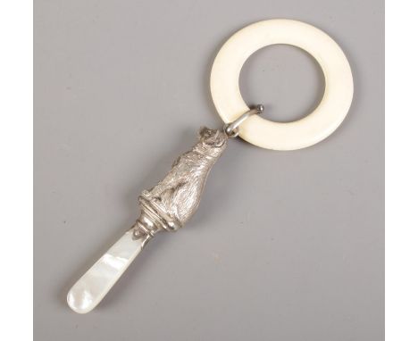 A silver and mother of pearl teething ring and rattle in the form of a dog. Assayed Chester, by W H Collins &amp; Co (date ma