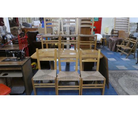 A Modern Pine Dining Room Suite Comprising Rectangular Refectory Table and Six Ladder Back Rush Seated Chairs 