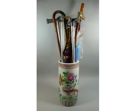 An Oriental Ceramic Stick Stand Containing Various Walking Sticks, Umbrellas, Shooting Stick Etc 