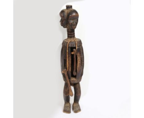 second half of the 20th century, the head carved with three faces above a elongated ring turned neck above a slit carved body