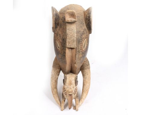 second half of the 20th century, having a pair of large ears and elliptical carved eyes surrounded by iron studs and having a