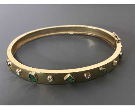 A 9ct gold emerald and diamond bangle, 19.2g