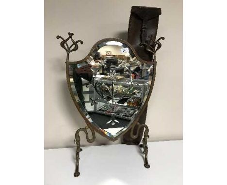 An antique leather gun slip and a mirrored etched shield fire screen 