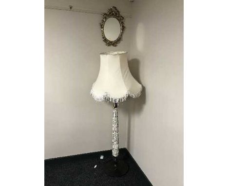 A decorative mahogany standard lamp with shade together with an ornate gilt framed mirror 