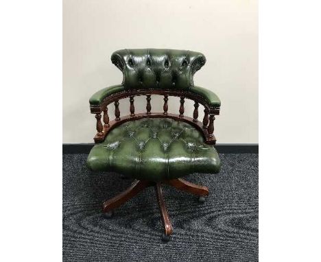 A green button leather Chesterfield swivel armchair 