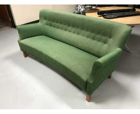 A mid 20th century shaped back settee in green button fabric 