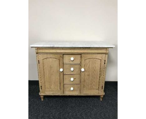 An early 20th century pine marble topped sideboard with white ceramic handles 