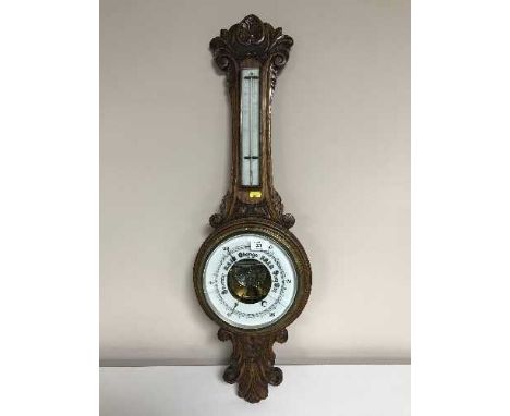 A carved oak cased banjo barometer 