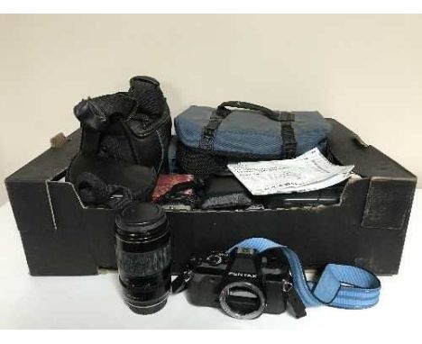 A box of camera bags containing video camera, digital camera, Pentax lens, Sanyo discman etc 