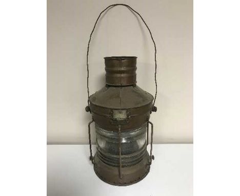 A copper ship's lamp by The Humber Ship Wright Company and a brass ship's porthole 