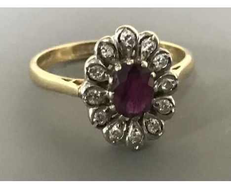 An 18ct gold ruby and diamond cluster ring, size N-O, 4.1g.