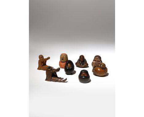 EIGHT JAPANESE WOOD NETSUKE OF DARUMA MEIJI PERIOD, 19TH CENTURY The Father of Zen Buddhism depicted in a variety of position