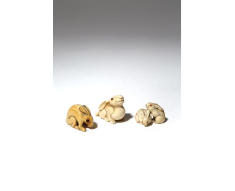 THREE JAPANESE IVORY NETSUKE OF RABBITS EDO AND MEIJI PERIOD, 19TH CENTURY One netsuke carved as a small rabbit resting its p