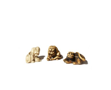 THREE JAPANESE IVORY NETSUKE OF TIGERS EDO PERIOD AND LATER, 18TH AND 19TH CENTURY One licking its cub, with the eyes inlaid 