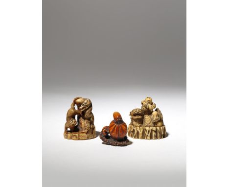 THREE JAPANESE IVORY NETSUKE EDO PERIOD AND LATER, 18TH AND 19TH CENTURY One depicting a tiger and a dragon on a rocky outcro