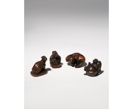 FOUR JAPANESE WOOD NETSUKE EDO PERIOD AND LATER, 18TH CENTURY AND LATER Two carved as tanuki racoon dogs, one reclining with 