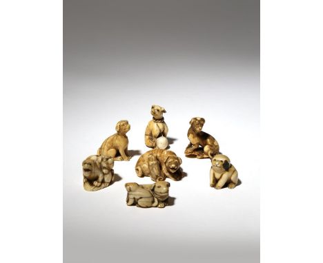 SEVEN JAPANESE IVORY NETSUKE OF DOGS EDO PERIOD AND LATER, 18TH AND 19TH CENTURY Depicted in a variety of positions, two with