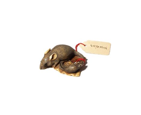 A JAPANESE IVORY NETSUKE OF RATS EDO PERIOD, 19TH CENTURY Carved as a large rat and its young on an open paper fan, the roden