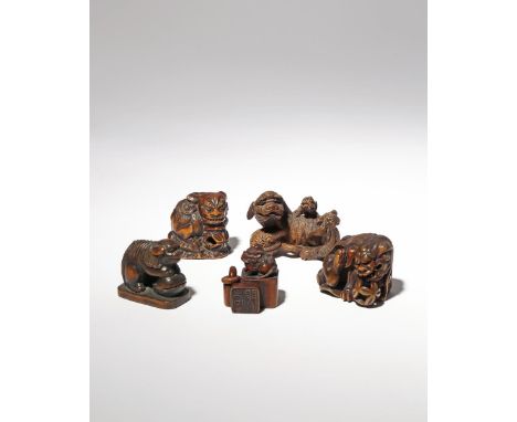 FIVE JAPANESE WOOD NETSUKE OF SHISHI MEIJI PERIOD, 19TH CENTURY The lion dogs depicted in a variety of positions, two with br