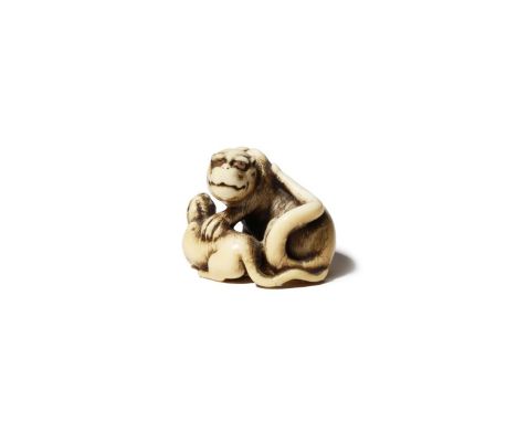 A JAPANESE IVORY NETSUKE OF A TIGER AND HER CUB EDO PERIOD, 18TH CENTURY The feline depicted with her head turned to sinister