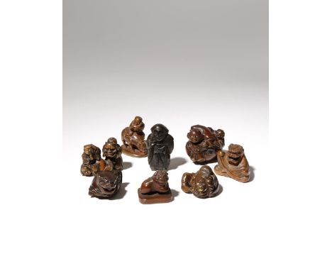 SIX JAPANESE WOOD NETSUKE OF BOYS MEIJI PERIOD, 19TH CENTURY Depicted engaged in a variety of activities, five wearing lion m