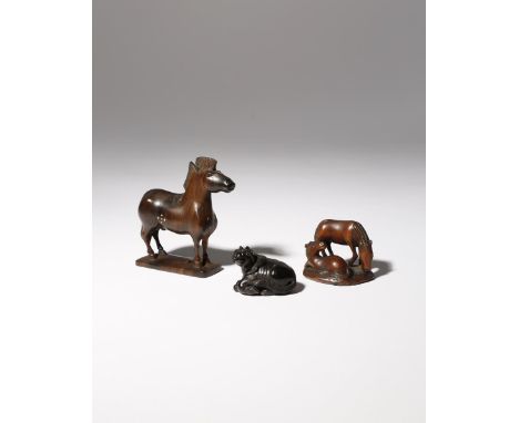 THREE JAPANESE WOOD NETSUKE OF HORSES MEIJI PERIOD, 19TH CENTURY The largest depicted standing on a rectangular base and with