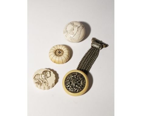 THREE JAPANESE MANJU NETSUKE AND ONE KAGAMIBUTA EDO PERIOD AND LATER, 19TH CENTURY One manju carved as a chrysanthemum flower