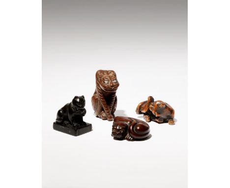 FOUR JAPANESE WOOD NETSUKE OF FELINES EDO PERIOD AND LATER, 18TH CENTURY AND LATER Two depicting tigers, one tall and seated 