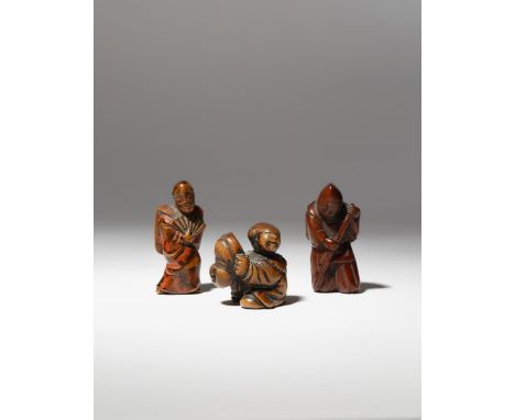 THREE JAPANESE WOOD NETSUKE OF FIGURES EDO AND MEIJI PERIOD, 18TH AND 19TH CENTURY One carved as a small child holding a mask