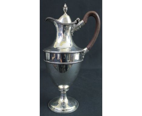 GEORGE III SILVER CLARET JUG of ovoid form, having beaded borders and hinged lid with vase and cover shaped finial. London 17