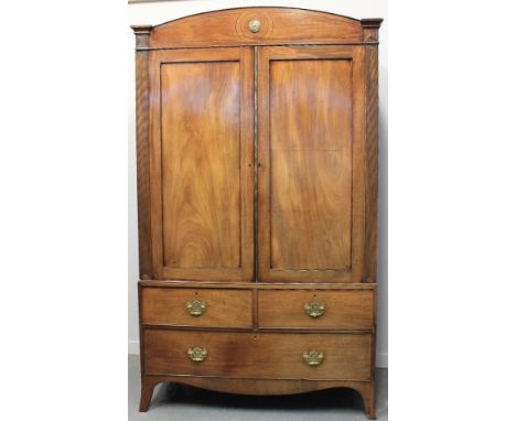 REGENCY MAHOGANY TWO STAGE PRESS CUPBOARD, having arch cresting with brass bullion over two panel doors with sliding shelves 