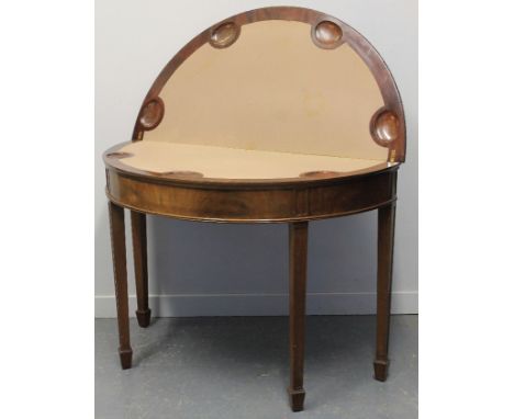 EARLY 20TH CENTURY GEORGIAN STYLE MAHOGANY DEMI LUNE FOLD OVER CARD TABLE, opening to reveal lined playing surface with guine