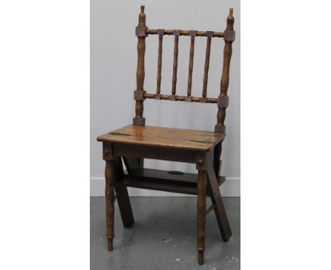 LATE 19TH CENTURY OAK METAMORPHIC LIBRARY CHAIR, having moulded stick back and solid seat, opening to form a set of three lib