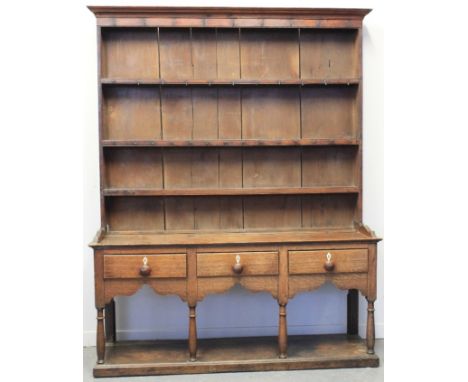 EARLY 19TH CENTURY WELSH OAK POT BOARD DRESSER, having moulded cornice over three shelf boarded rack back with iron hooks, th
