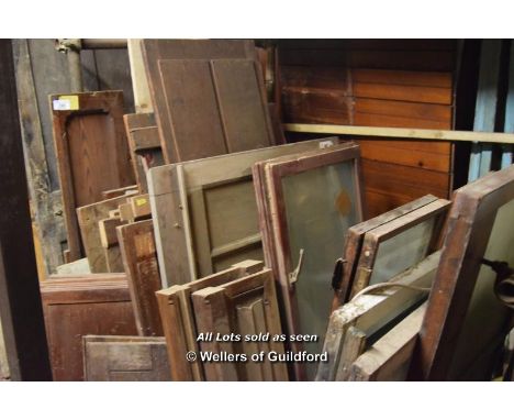 *A BAY CONTAINING MIXED PANELS, SMALL DOORS AND WINDOWS INC. SASH