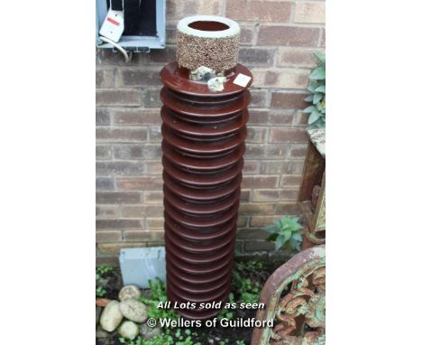 *CERAMIC ELECTRICITY INSULATOR, SET UP AS A WATER FEATURE. LATE 1900S