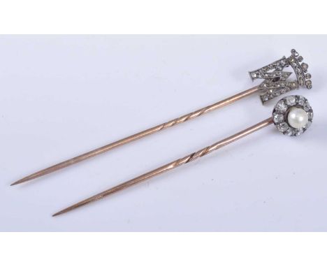 Two yellow and white metal diamond set stick pins, one comprising a royal monogram surmounted by a crown with thirty-seven 0.