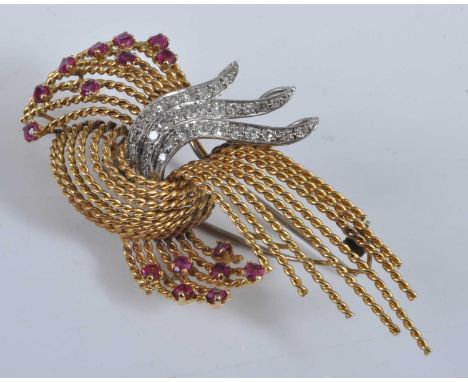 A yellow and white metal, ruby and diamond spray brooch, comprising multiple twisted strands set with 16 round faceted rubies