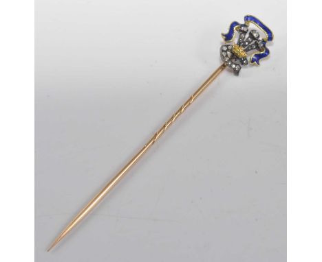 A yellow and white metal, enamel and diamond stick pin, depicting a fleur de lys emblem set with eighteen 0.7 to 1.65mm rose 