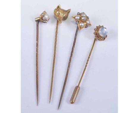 Four yellow metal stick pins, being a yellow metal quatrefoil pearl cluster featuring four 3.5mm cultured pearls and four 1.6