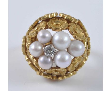 A yellow metal, pearl and diamond bombe ring, featuring a centre round brilliant cut diamond surrounded by six 4 to 5.1mm cul