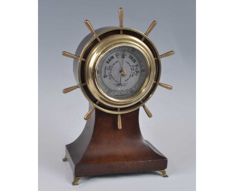 Henry Browne &amp; Son Ltd of Barking &amp; London - an oak ships wheel barometer, of balloon shape, with signed silvered sca