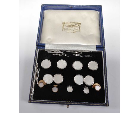 A 9ct white gold button, cufflink and dress stud set, the four 14mm diameter buttons with chequerboard mother of pearl inlay,