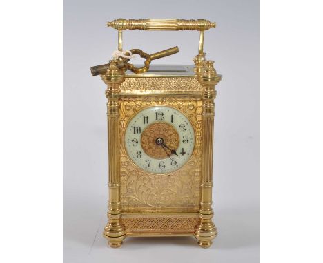 A circa 1900 French lacquered brass carriage clock, the fancy case having four fluted three-quarter turned pilasters flanking