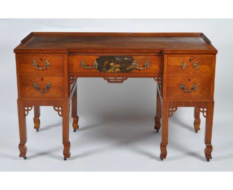 A circa 1900 Japanese influenced satinwood inverted breakfront kneehole writing desk, having gilt tooled leather inset writin