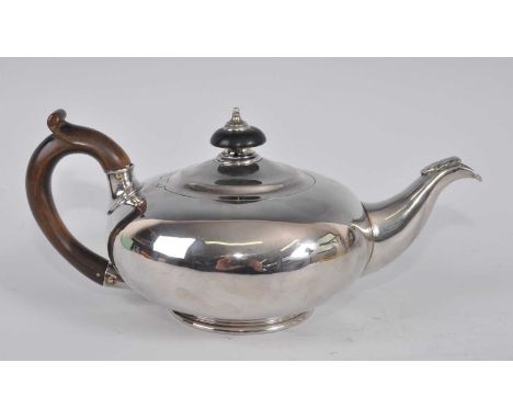 A William IV silver bachelors teapot, of plain squat circular form on stepped footrim, with applied acanthus leaf to spout, e