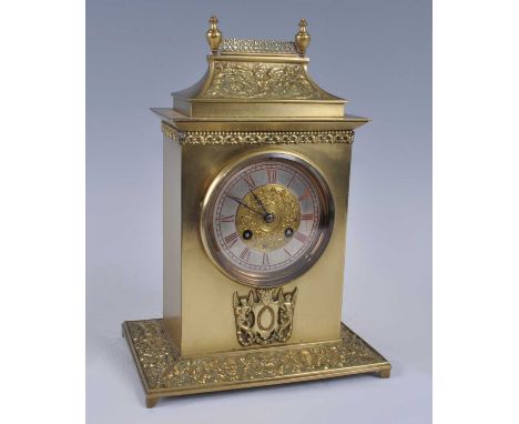 A late 19th century gilt brass cased mantel clock, having an unsigned silvered chapter ring with embossed brass centre, twin 