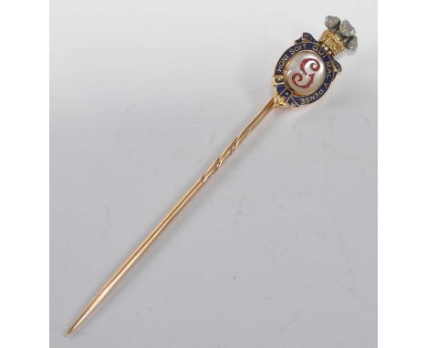 A yellow metal George Prince of Wales stick pin, featuring an oval reverse crystal with initial G, blue enamel surround 'Honi