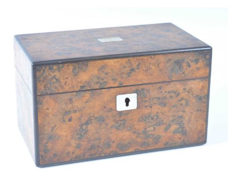 An early Victorian burr elm tea caddy, having mother of pearl inset hinged cover opening to reveal two calamander fitted cadd