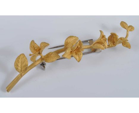 A yellow metal bar brooch in the form of a flowering branch, with white metal roller catch fastening, brooch length 72mm, gro